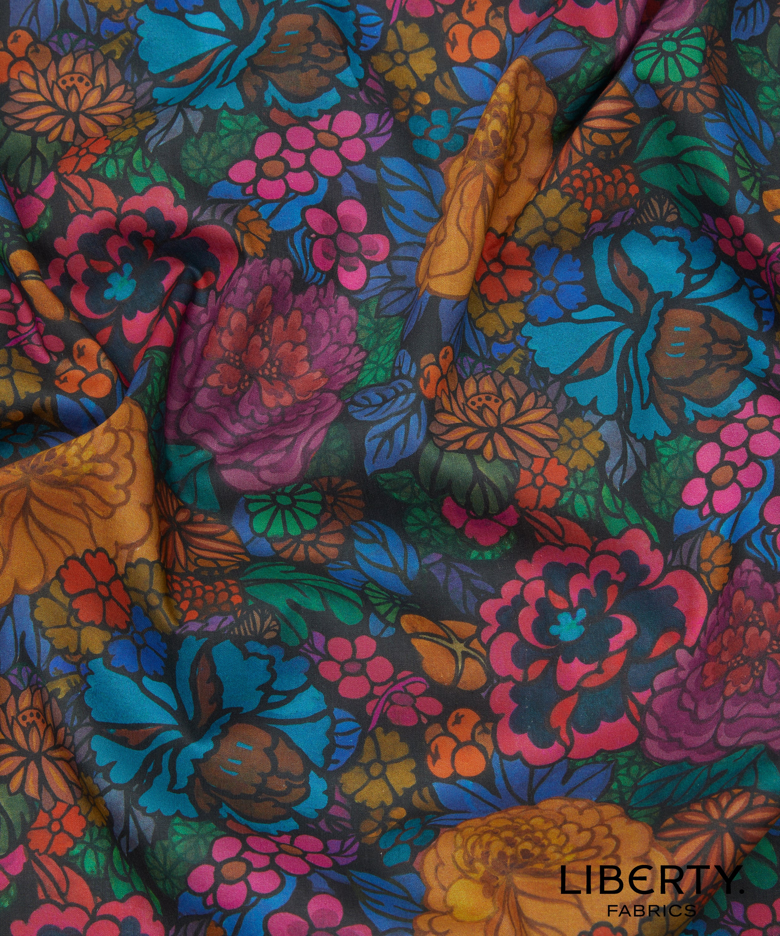 Colorful floral fabric by Liberty Fabrics stylised chrysanthemums, peonies, hidden fruits, and delicate Japanese blossom