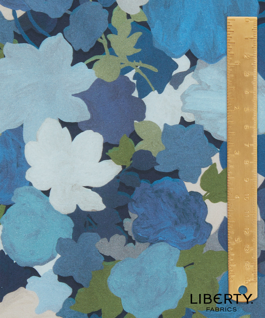 Floral fabric pattern featuring blue, green, and white flowers by Liberty Fabrics 